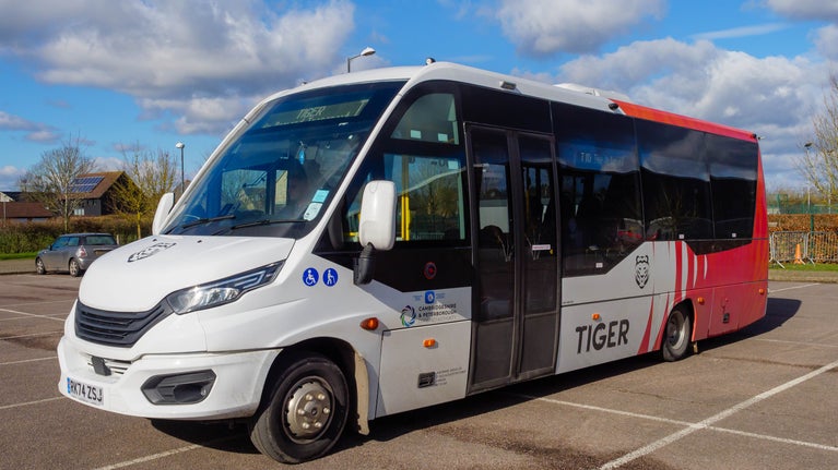 A close-up view on white minibus viewed from the front